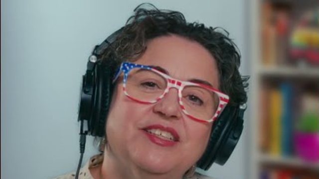 Host Carolina in headphones at the radio show desk