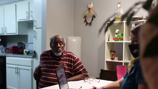 Case manager meeting with a client at his kitchen table